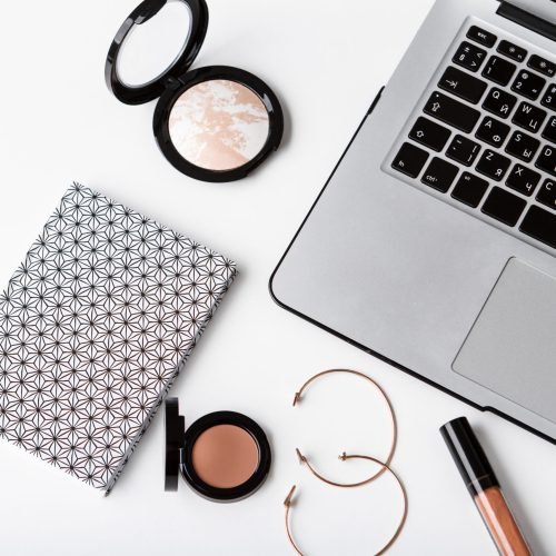 Set of decorative cosmetics notebook laptop and accessories over white background. Copy space.
